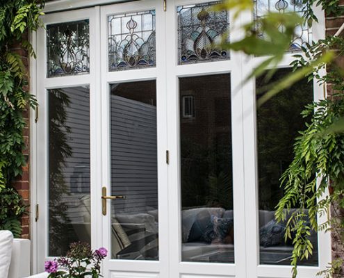 Stained glass panels in bifold doors