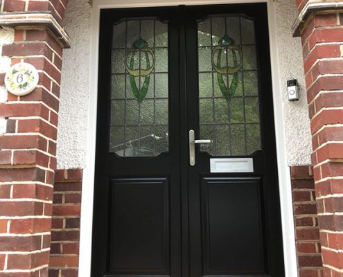 Black timber door within porchway