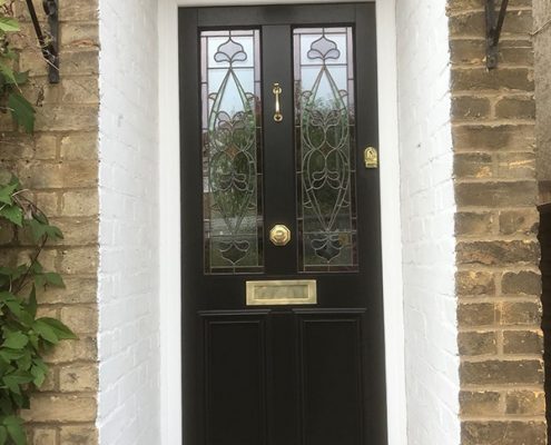 Black timber door with small porch