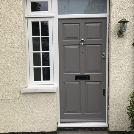 Grey timber door with glazing