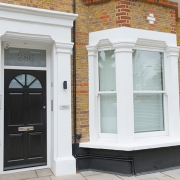 Black timber front door and white timber windows