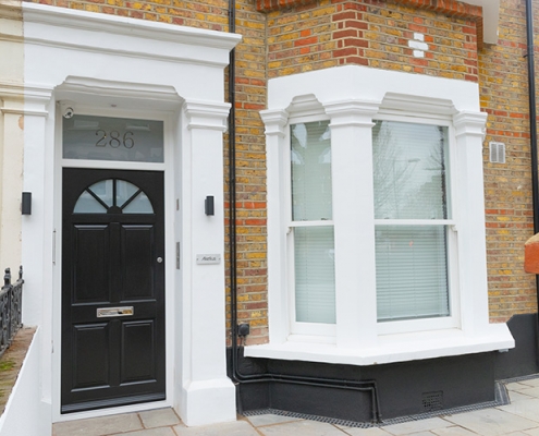 Black timber front door and white timber windows
