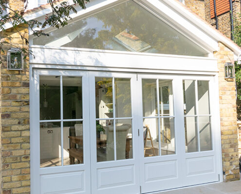 Exterior view of white timber bifold doors