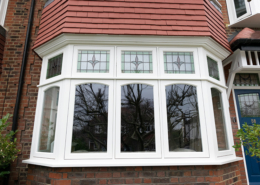 Timber bay window Timber bay window with stained glass fan lights