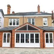 Timber bifold door installation with apex windows above