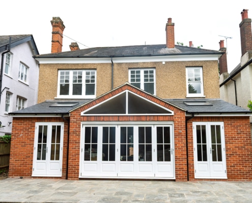 Timber bifold door installation with apex windows above